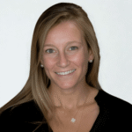 Headshot_Bergen_Jamie - Texas Healthcare Trustees Head and shoulders portrait of a smiling blonde woman in a black top against a light background