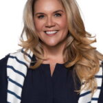 WPLN Summit 2025 - Headshot Gallery - Texas Healthcare Trustees Smiling woman with long blonde hair wearing a navy top and white navy striped cardigan against a white background